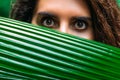 Portrait of a girl with beautiful brown eyes. Portrait of a girl in close-up. Portrait of a girl with a green leaf. Royalty Free Stock Photo