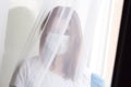 Portrait of a girl behind glass in a protective face mask Royalty Free Stock Photo
