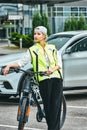 Portrait of a girl on bicycle in an emergency vest Royalty Free Stock Photo