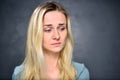 Portrait of a girl blonde, disappointed woman, closeup