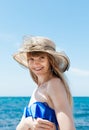 Portrait of girl in blue swimwear top and broad-brim hat