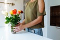 Portrait girl with bouquet of multi-colored roses at home