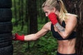 Portrait of girl boxer doing uppercut kick working out outdoors. Royalty Free Stock Photo