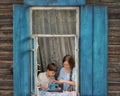 Portrait of girl and boy kids tailor sew making doll& x27;s clothes on a children& x27;s sewing machine in the window of Royalty Free Stock Photo