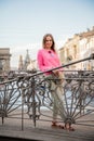 portrait of a girl on the bridge against the backdrop of a beautiful city