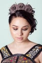 Portrait of a girl brunete with hair beam with a delicate make up and a wreath in her hair from black roses with thorns rock Royalty Free Stock Photo