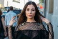 Portrait of a girl, brunette, in a black dress, in the arch, in the city. posing, walking. alone in the crowd, loneliness Royalty Free Stock Photo