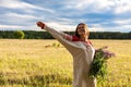 Portrait of a girl with a bunch of willow-herb in a green field