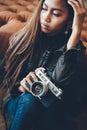 Portrait of a girl with camera and in fashionable style