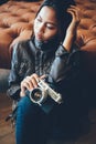 Portrait of a girl with camera and in fashionable style