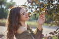 Portrait of a girl carried tree branches, bright day in the summer in the backlight. At shallow depth of field