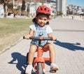 Portrait, girl child and cycling on sidewalk, learning to ride bike or healthy childhood development. Happy kid riding Royalty Free Stock Photo