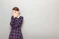 Portrait of girl covering face with hands and looking through fingers Royalty Free Stock Photo