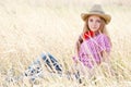 Portrait of the girl - cowboy in a grass