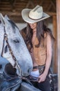 Portrait of a girl with cowboy hat and her horse. Royalty Free Stock Photo