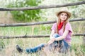 Portrait of the girl - cowboy at an old fence Royalty Free Stock Photo