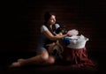 portrait of a girl with a dog washing things in a basin. dark background Royalty Free Stock Photo