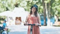 Portrait of a girl on an electric scooter posing in a park in the summer. Royalty Free Stock Photo