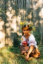 Portrait of a girl in an embroidered wreath and a wreath of viburnum