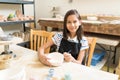 Girl Enhancing Her Pottery Painting Skill In Class