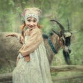 Portrait of a girl in the forest with a goat