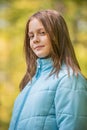 Portrait of girl in the forest smiling to the camera. A girl with long hair in autumn forest Royalty Free Stock Photo