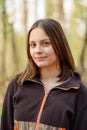 Portrait of girl in the forest smiling to the camera. A girl with long hair in forest Royalty Free Stock Photo