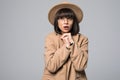 Portrait of young girl get freeze wearing overcoat and hat isolated on white background Royalty Free Stock Photo