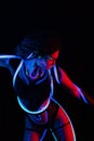 Portrait of a Girl with Glowing Tubes in Neon UF Light. Model Girl with Dreadlocks and Fluorescent Creative Psychedelic