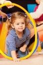 Portrait of a girl go though hoop in active game Royalty Free Stock Photo