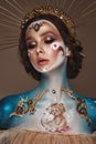 Portrait of a girl with gold and blue creative art make-up. Royalty Free Stock Photo