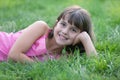 Portrait of a girl on the green grass and holding Royalty Free Stock Photo