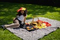 Portrait of a girl in a hat of the Belgian flag in the park at a picnic. Royalty Free Stock Photo