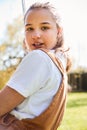 Portrait Of Girl Having Fun On Tyre Swing In Garden At Home Royalty Free Stock Photo