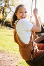 Portrait Of Girl Having Fun On Tyre Swing In Garden At Home Royalty Free Stock Photo