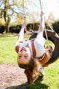 Portrait Of Girl Having Fun On Tyre Swing In Garden At Home Royalty Free Stock Photo