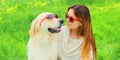 Portrait girl with her Golden Retriever dog wearing a sunglasses on green grass Royalty Free Stock Photo