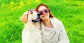 Portrait girl with her Golden Retriever dog wearing a sunglasses on green grass Royalty Free Stock Photo