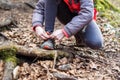 Portrait of girl on hiking forest trip tying shoe laces