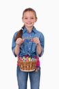 Portrait of a girl holding a basket full of Easter eggs