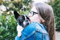 Portrait of girl hugging a puppy boston terrier dog Royalty Free Stock Photo