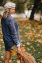 Portrait of a Girl in a jacket and birette with an autumn bouquet in an autumn park