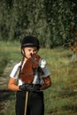 Portrait of a girl - a jockey, who holds a horse - a toy in her hands Royalty Free Stock Photo