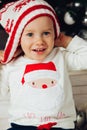 Portrait of girl in knitted hat and sweater with santa Royalty Free Stock Photo