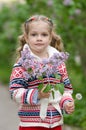 Portrait of girl with lilacs and dandelions in the hands Royalty Free Stock Photo