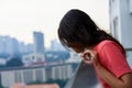 Portrait of a girl looking at the buildings of a big city from the balcony of a skyscraper Royalty Free Stock Photo