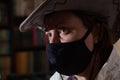 Portrait of a girl in a medical mask and a cowboy hat. Royalty Free Stock Photo