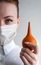 Portrait of a girl in a medical mask. Holding a syringe in her hand. Close up Royalty Free Stock Photo