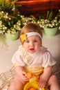 Portrait girl one year old shooting in the studio in the background flowers wooden background dekor Royalty Free Stock Photo