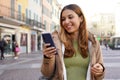 Portrait of girl outdoor messaging with chatting app on smartphone in pedestrian area Royalty Free Stock Photo